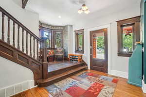 Entryway with hardwood flooring, plenty of natural light, and historic baseboards