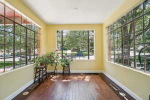 Unfurnished sunroom featuring healthy amount of natural light - with original windows