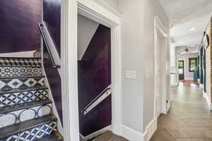 Staircase with baseboards, tile patterned flooring, and recessed lighting