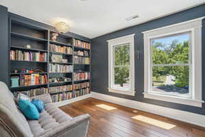 Library area featuring historic baseboards and wood flooring