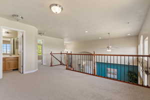 Hallway featuring recessed lighting, an upstairs landing, light colored carpet, and baseboards