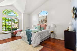 Bedroom featuring vaulted ceiling and wood finished floors