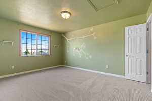 Empty room featuring carpet floors and baseboards