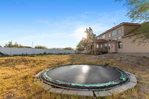 View of yard featuring a trampoline