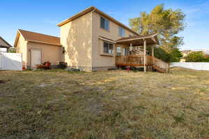 Back of property with a wooden deck, stucco siding, and central air condition unit