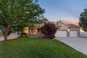 Obstructed view of property featuring stucco siding, concrete driveway, an attached garage, a porch, and stone siding