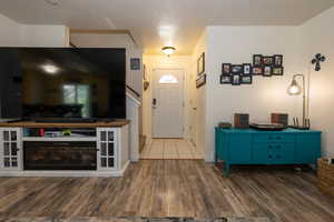 Entryway with wood finished floors and baseboards