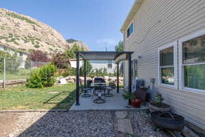 View of yard with a pergola, a mountain view, and a patio area