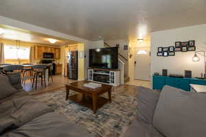 Living area with stairway and light tile patterned floors