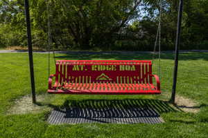 Community / neighborhood sign featuring a yard