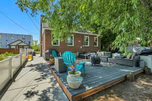 Deck with an outdoor living space with a fire pit and area for grilling