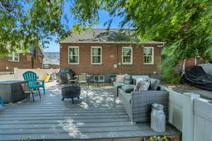 Deck featuring an outdoor living space with a fire pit and grilling area