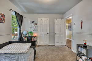 Bedroom featuring carpet floors and baseboards