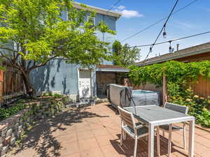 Fenced backyard featuring a patio area and outdoor dining area
