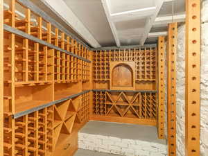 Wine room featuring concrete floors