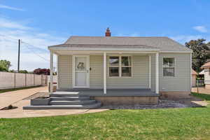 Bungalow-style house with covered porch and a chimney