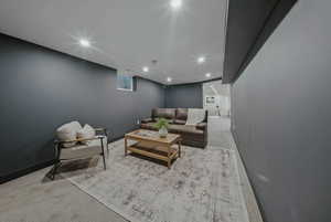 Living area featuring carpet floors and baseboards