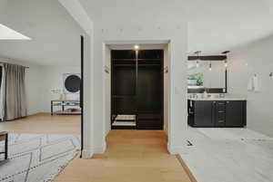 Hall featuring light wood-style floors