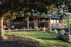 Rear view of property with a yard and brick siding