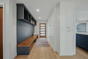 Mudroom featuring light wood-style flooring, baseboards, recessed lighting, and plenty of natural light