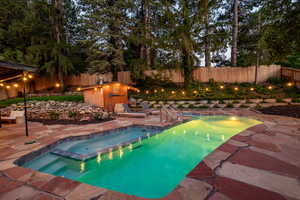 View of pool with a patio area, a fenced backyard, and a pool with connected hot tub