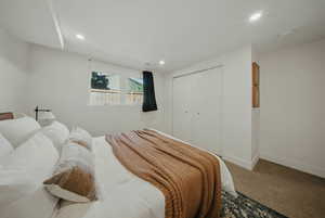 Bedroom featuring baseboards, carpet floors, recessed lighting, and a closet