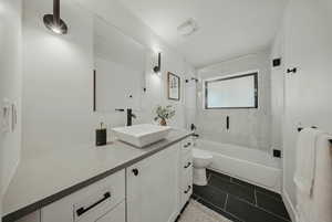 Bathroom featuring vanity, toilet, bathing tub / shower combination, and tile patterned floors