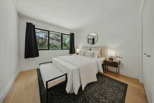 Bedroom featuring light wood-type flooring and baseboards