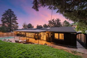 View of front of home with a chimney and a patio area