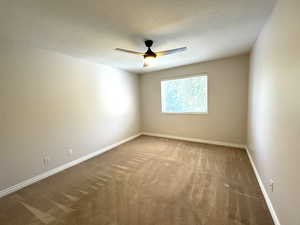 Main level bedroom featuring ceiling fan and large closet with organizer.