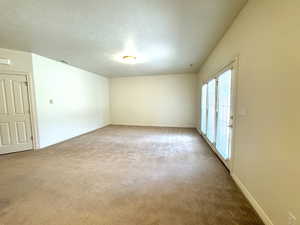 Family room with high ceiling and walkout to patio.