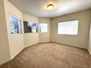 Bedroom with walk-in closet and bay window.