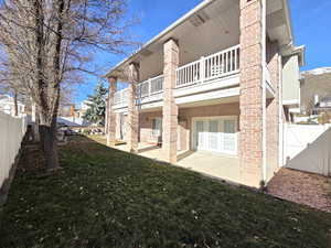Rear view of property with a covered deck and covered patio.
