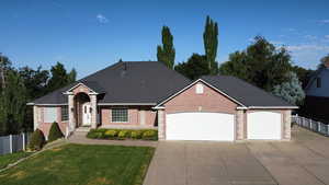 Front View of house features Full Brick, newer roof, 3 Car Oversized Garage, RV Driveway