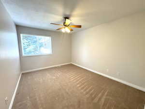 Main level bedroom featuring ceiling fan and large closet with organizer.
