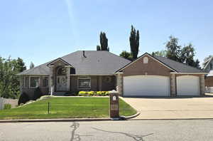 View of front with 3 car garage, rv driveway, full brick Exterior.
