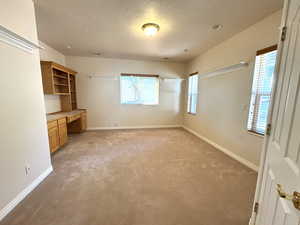 Bedroom featuring built-in cabinets, sink and walk-in closet.