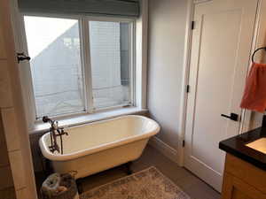 Clawfoot tub with entrance to walk-in closet