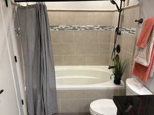 Full bath down with garden tub, shower combination and custom tile