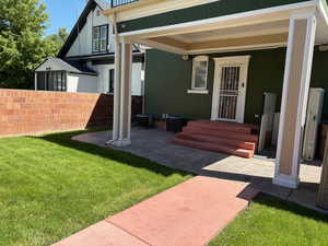 Covered patio off back door with deck above
