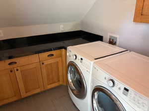 Laundry room up with cabinet space with washer/dryer hook-ups and counters for doing crafts or projects