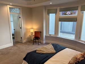 Bay window in primary bedroom with stained glass, automated shades and lots of natural light