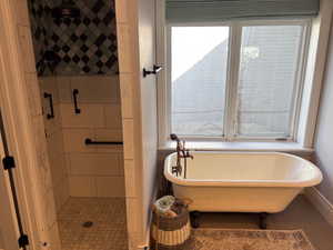 Walk-in shower with grab bars and a clawfoot tub