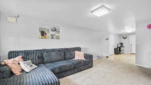 Carpeted living room with baseboards