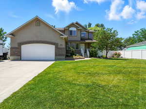 View of front of home featuring stucco siding, a garage, and driveway