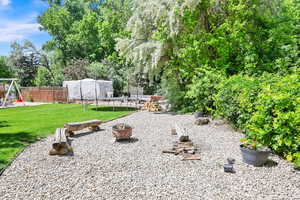 View of yard with a fire pit, a playground, and a trampoline (excluded from sale) and Secluded RV Parking behind