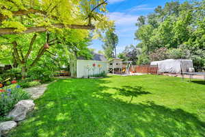 View of yard upper terraced yard with shed, playgRound and GATED AND SECLUDED RV parking behind