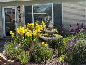 Exterior view of brick siding and front flower bed with beautiful perennial's