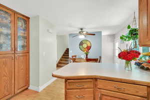 U Shaped Kitchen with white appliances, free standing range, range hood, and light colored laminate countertops