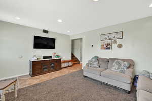 Living area with recessed lighting and tile entry